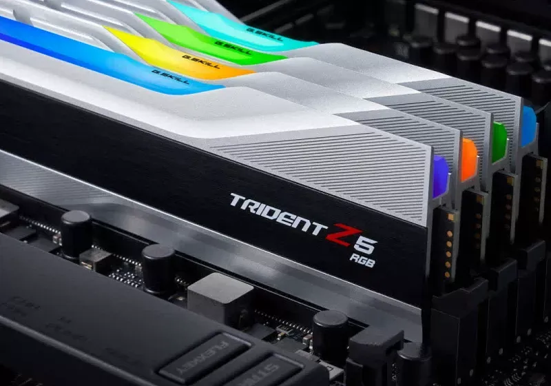 DDR4 memory modules and older motherboard components arranged on a workbench.