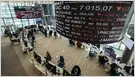 Financial analysts review stock market data related to customer service outsourcing.