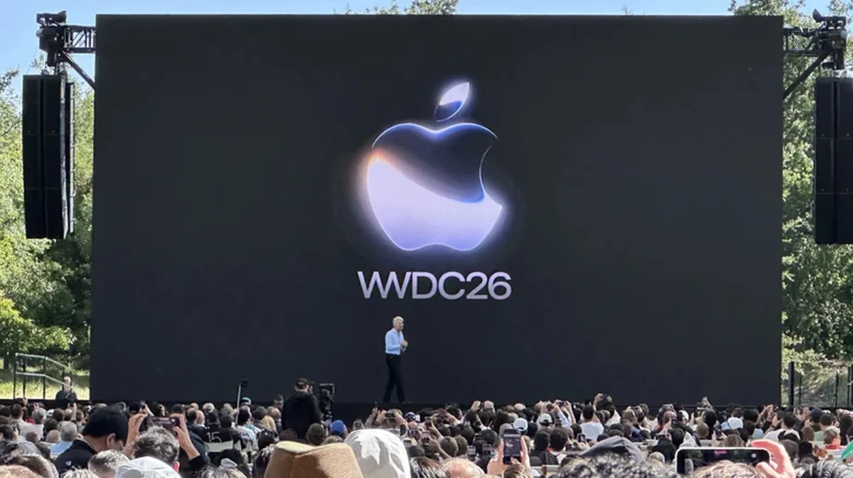 The presentation stage highlights Apple WWDC 2026 announcements on measured AI rollout and system stability updates.
