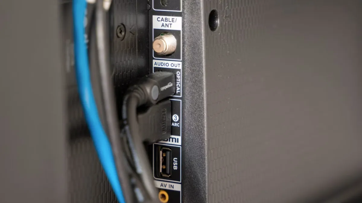 The television rear panel displays multiple universal serial bus ports for media playback and charging.