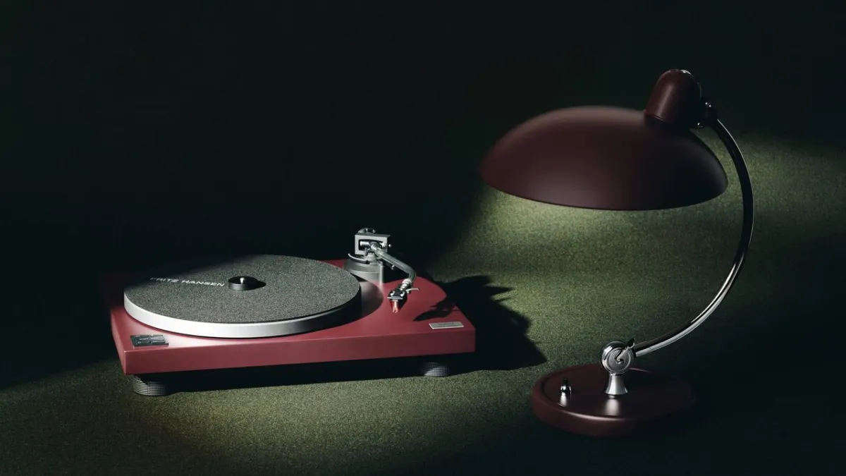 Technics direct-drive turntable and Fritz Hansen table lamp in matching oxblood red finish.
