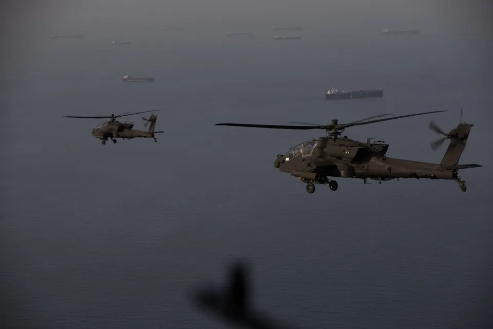 Iranian Shahed drone and US Army Apache helicopter during aerial engagement near the Strait of Hormuz.