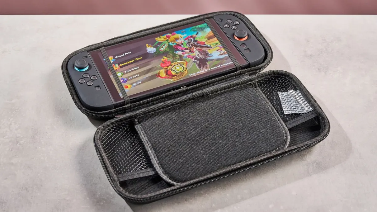A Nintendo Switch 2 console rests on a flat surface alongside its Joy-Con controllers and a game cartridge.