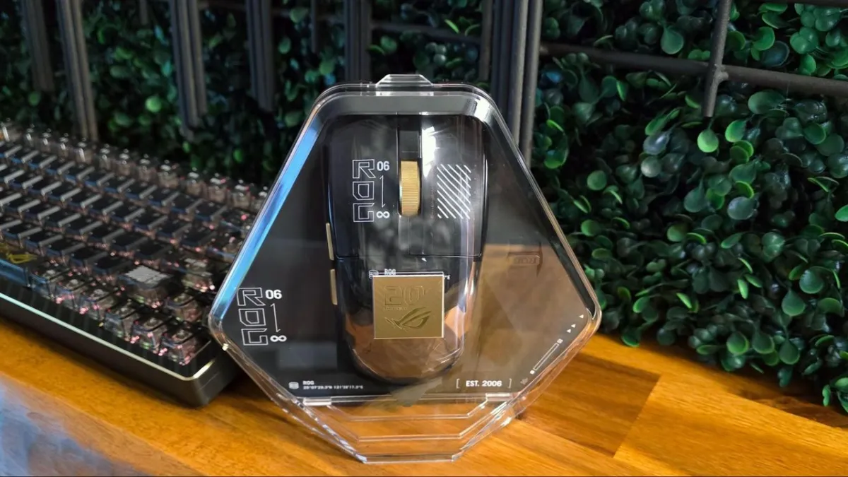 Gold and black Asus ROG Harpe II Extreme Edition 20 gaming mouse with a transparent back panel.