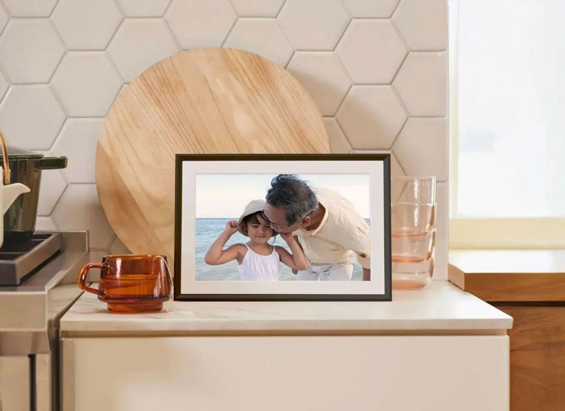 An Aura digital photo frame displays synchronized Google Photos albums via the new Ambient API.