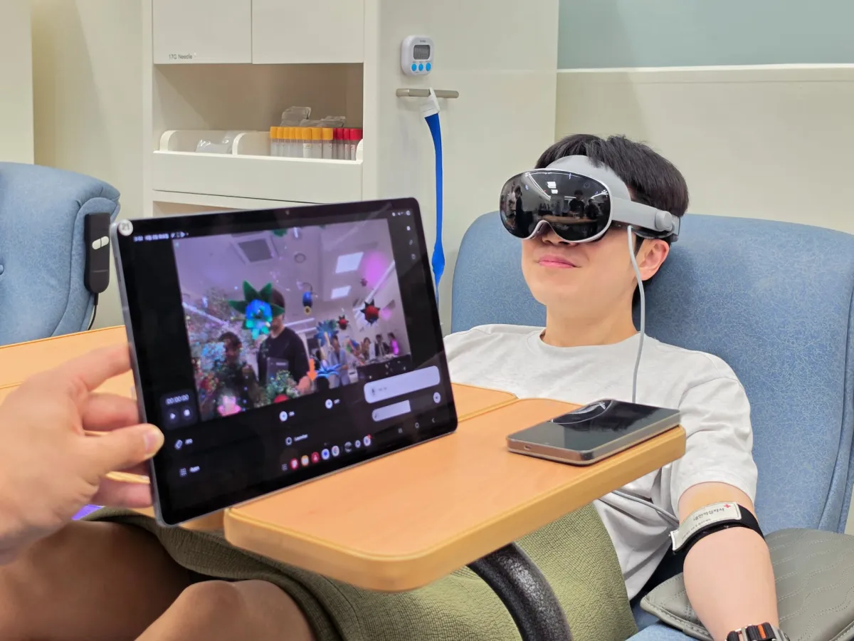 A person wears a Samsung Galaxy XR headset during a blood donation session.