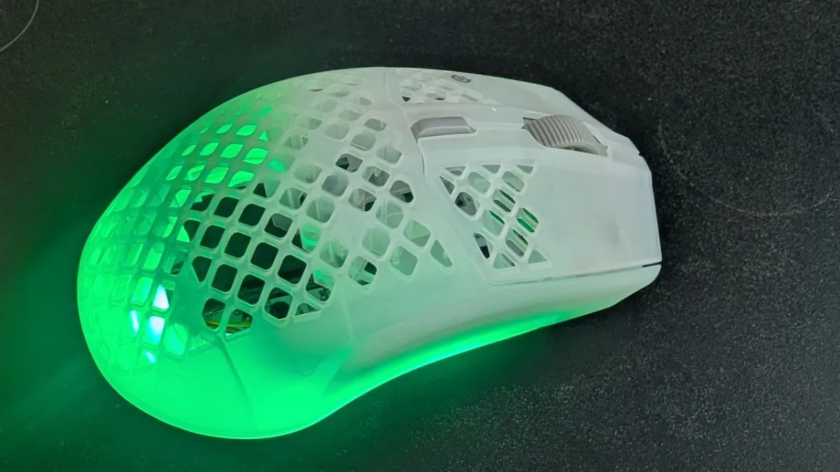 SteelSeries Aerox 3 Wireless Gen 2 mouse with honeycomb chassis and wireless receiver.