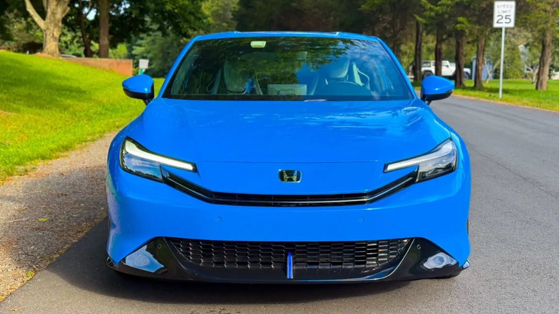 The 2026 Honda Prelude grand touring vehicle is shown from the side to highlight its exterior profile and hybrid powertrain.