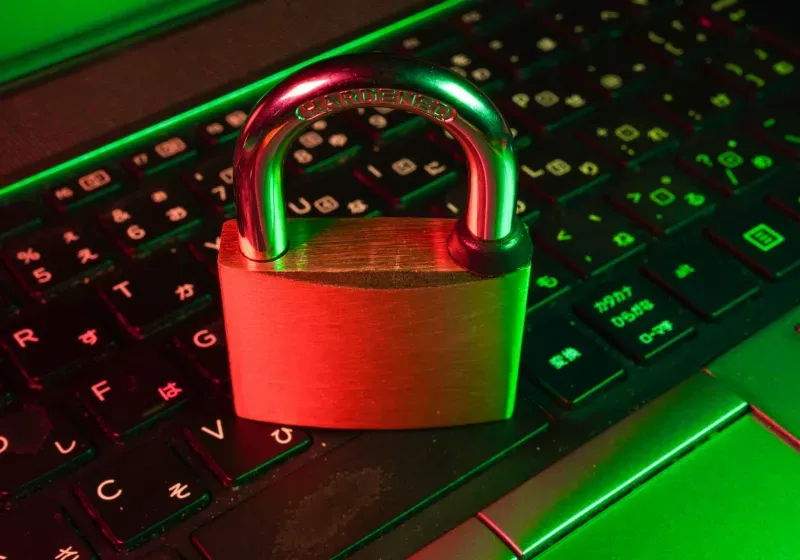 A computer screen displays a Dashlane security warning about unauthorized login attempts.