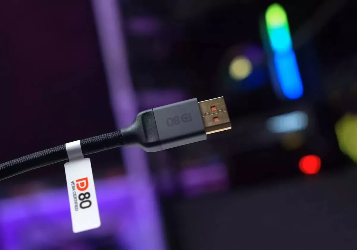 DisplayPort cable connected to a graphics card and monitor, showing how cable choice impacts UHBR20 performance.