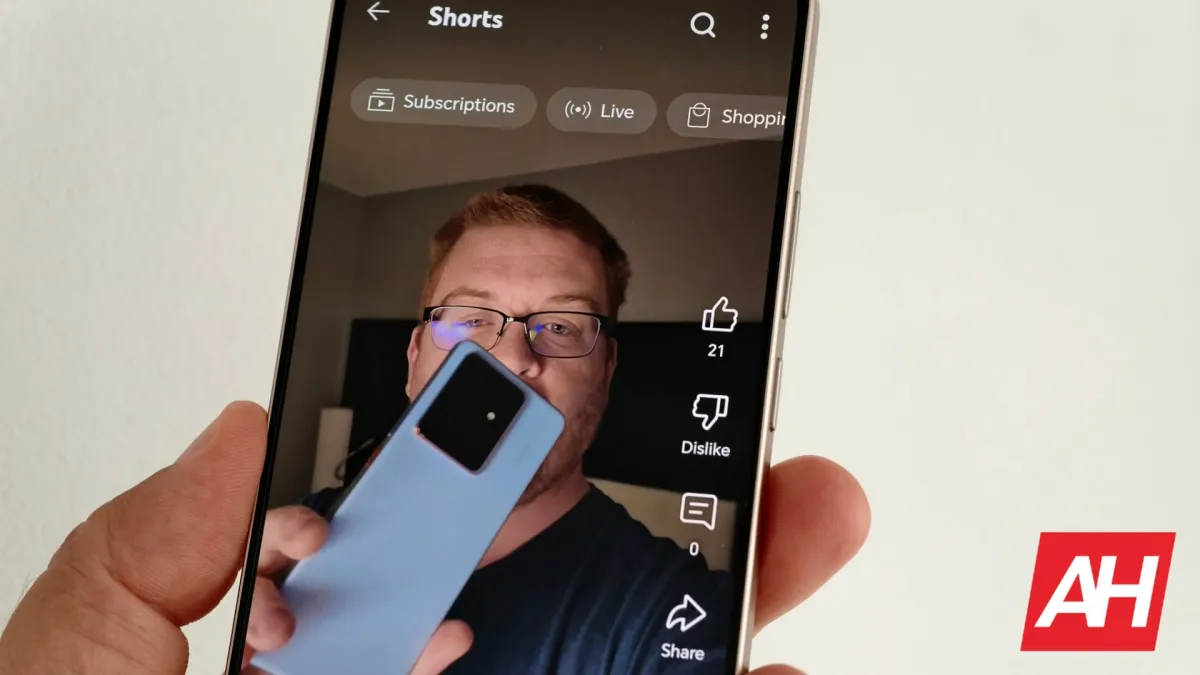 The YouTube Shorts interface displays a heart icon in place of the standard thumbs-up like button.