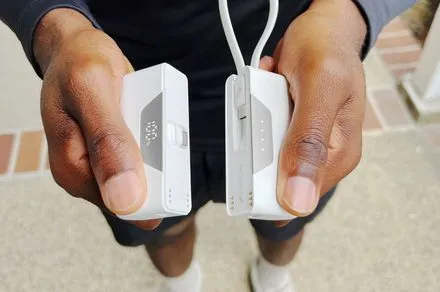 The Nimble SHAREPOWER charger is shown separated into two independent battery units on a flat surface.