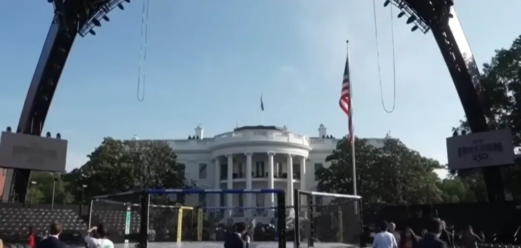 Construction crews build a mixed martial arts tournament venue on the White House South Lawn.
