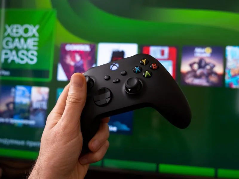 Xbox logo and controller resting on a desk