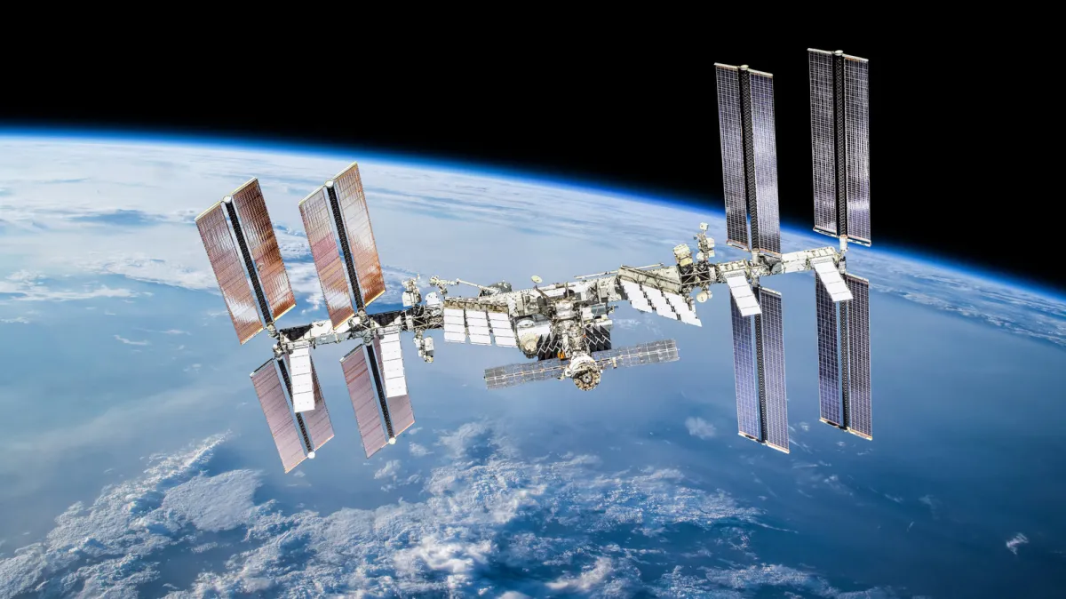 ISS crew members shelter inside a docked SpaceX Dragon capsule after an air leak was found in the Zvezda service module.