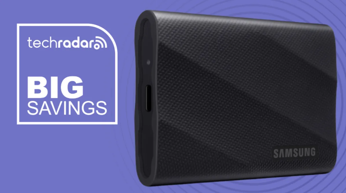 The Samsung T9 portable SSD rests on a white surface alongside a USB-C cable.