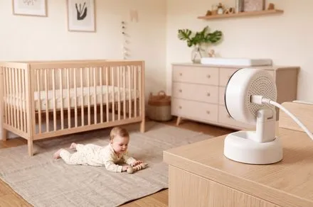 Momcozy BM08 smart baby monitor showing millimeter-wave sensor data and automated health tracking interface.
