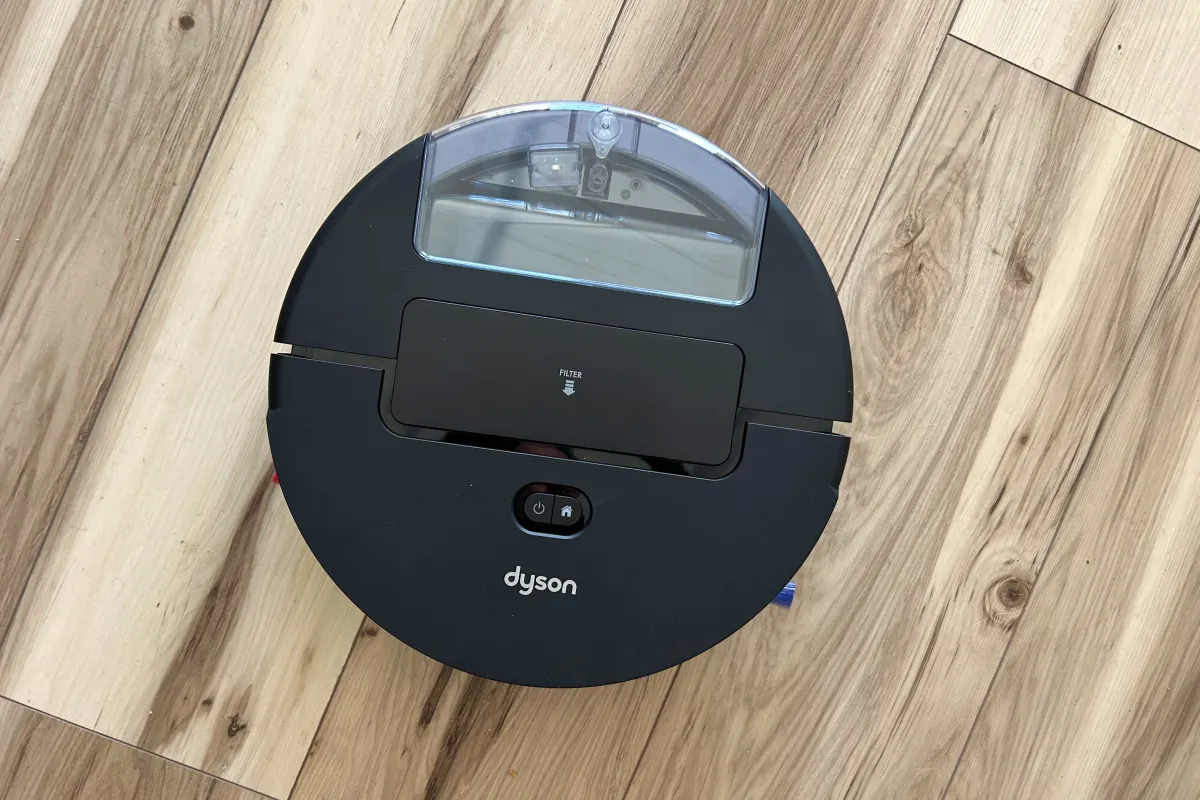 A robot vacuum navigates a living room floor while avoiding furniture obstacles.