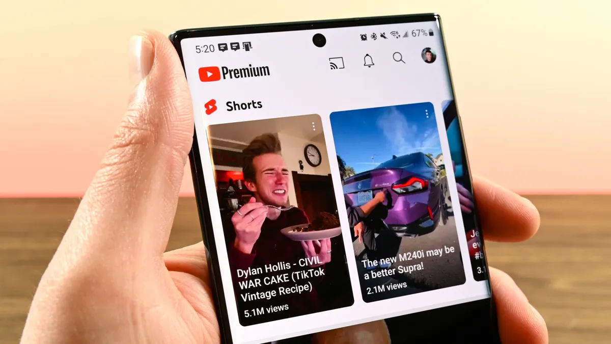 YouTube Shorts interface showing new feedback design with heart icon replacing like button and dislike button moved to menu.