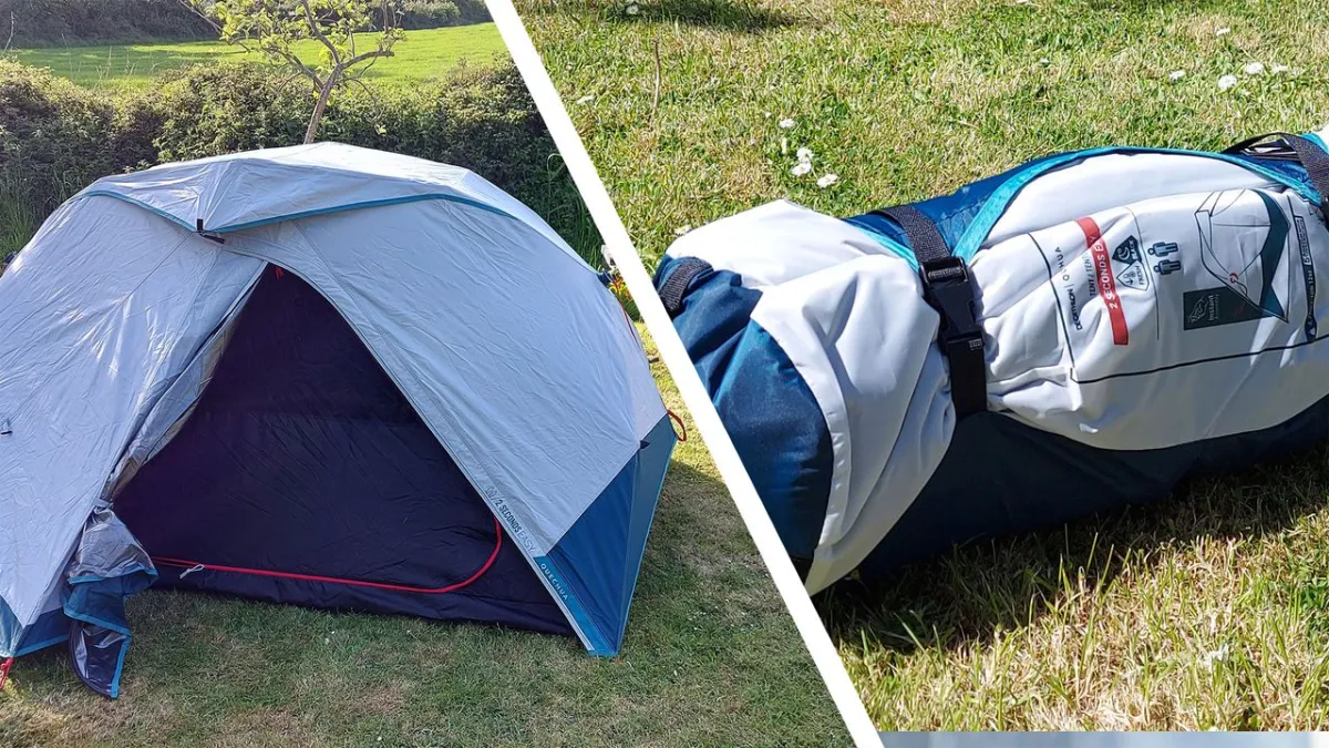 A compact camping tent stands fully assembled on a grassy field with its rainfly secured and frame aligned.