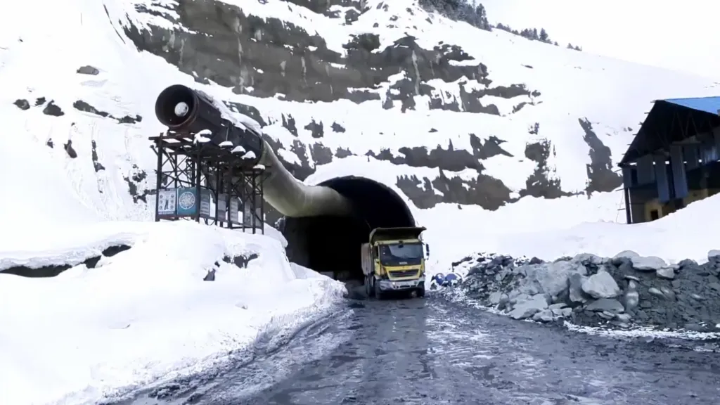 Construction crews complete the final rock section of the Zojila tunnel in the Himalayas.