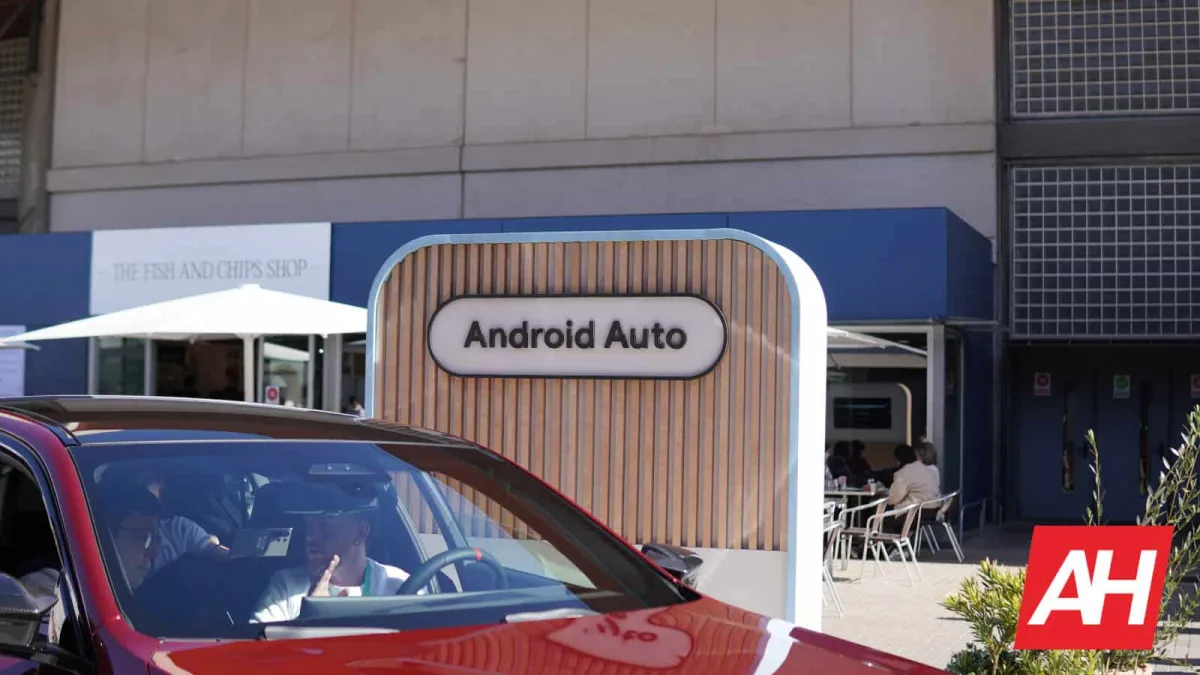 A smartphone displays the Android Auto interface while connected to a vehicle dashboard