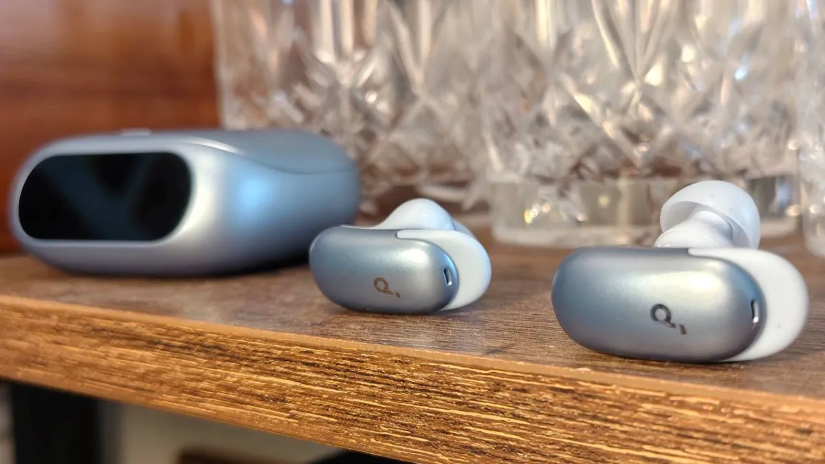 The Anker Soundcore Liberty 5 Pro earbuds rest beside their charging case on a clean surface.