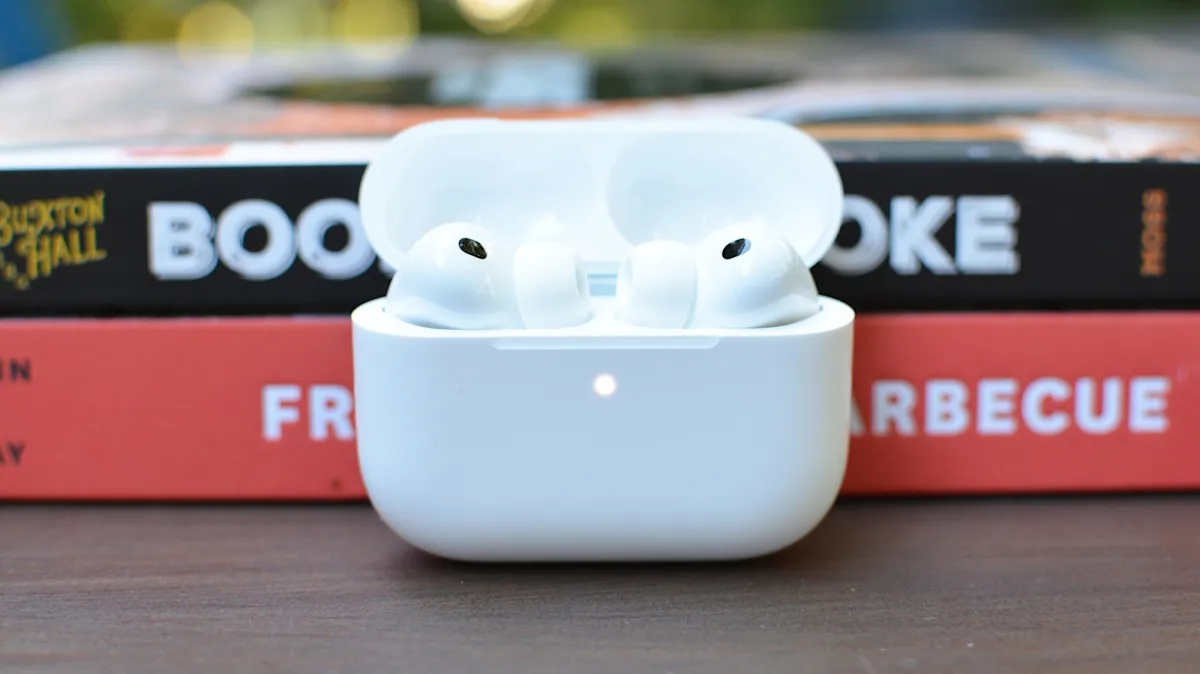 The iOS 27 settings screen displays the new AirPods equalizer controls with adjustable frequency sliders.