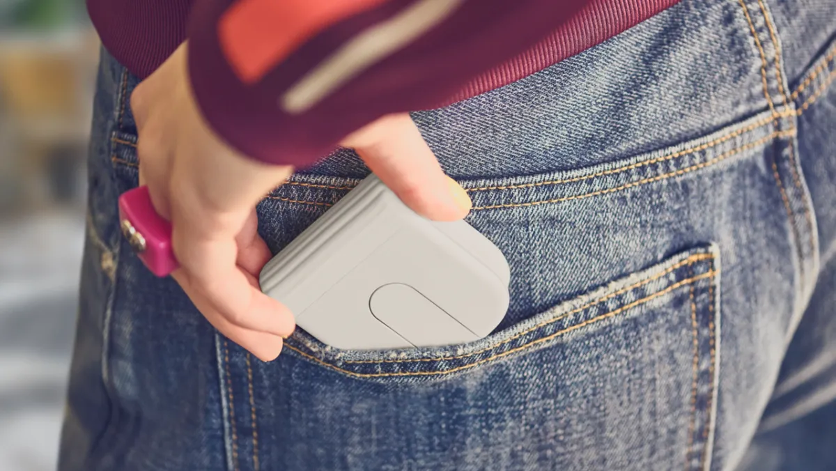 Logitech Mobi Fold wireless mouse shown folded for pocket storage, featuring a scroll trackpad and side buttons.
