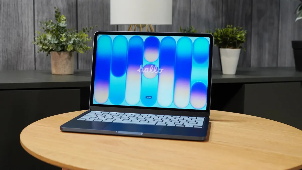 Dell XPS 13 laptop with an open OLED display and silver chassis