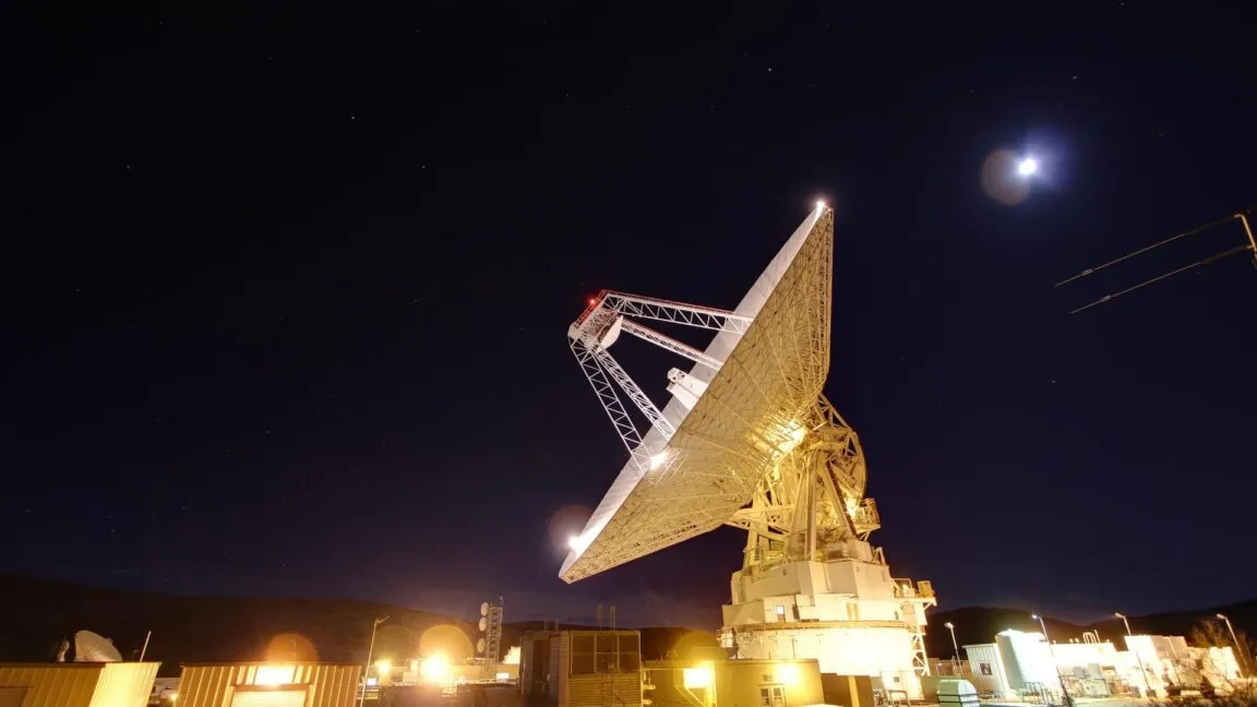 A NASA Deep Space Network radio antenna array supports Artemis II mission communications.