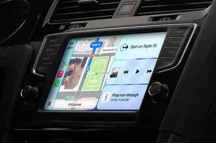 The updated CarPlay interface displays new media controls, navigation maps, and voice assistant features.