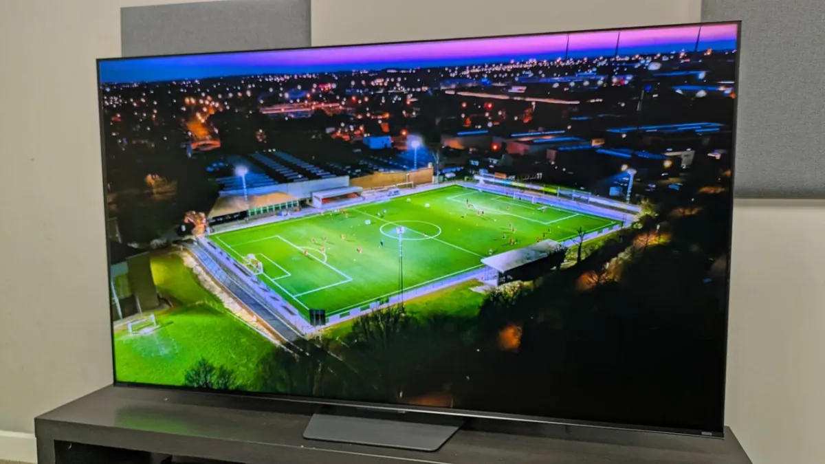 Television screen showing a football match with high brightness and motion clarity.