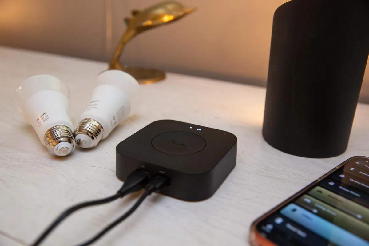 The Philips Hue Bridge Pro smart lighting hub shows status LEDs and network ports.