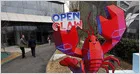 Office workers leave a corporate building in China as companies implement AI-driven staff reductions.
