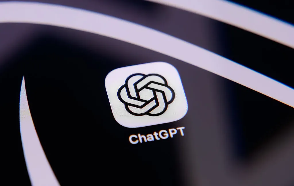 A laptop displaying a chatbot conversation next to legal case files