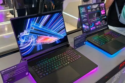 The display features portable laptops with integrated AI processors and ergonomic keyboards at Computex 2026.