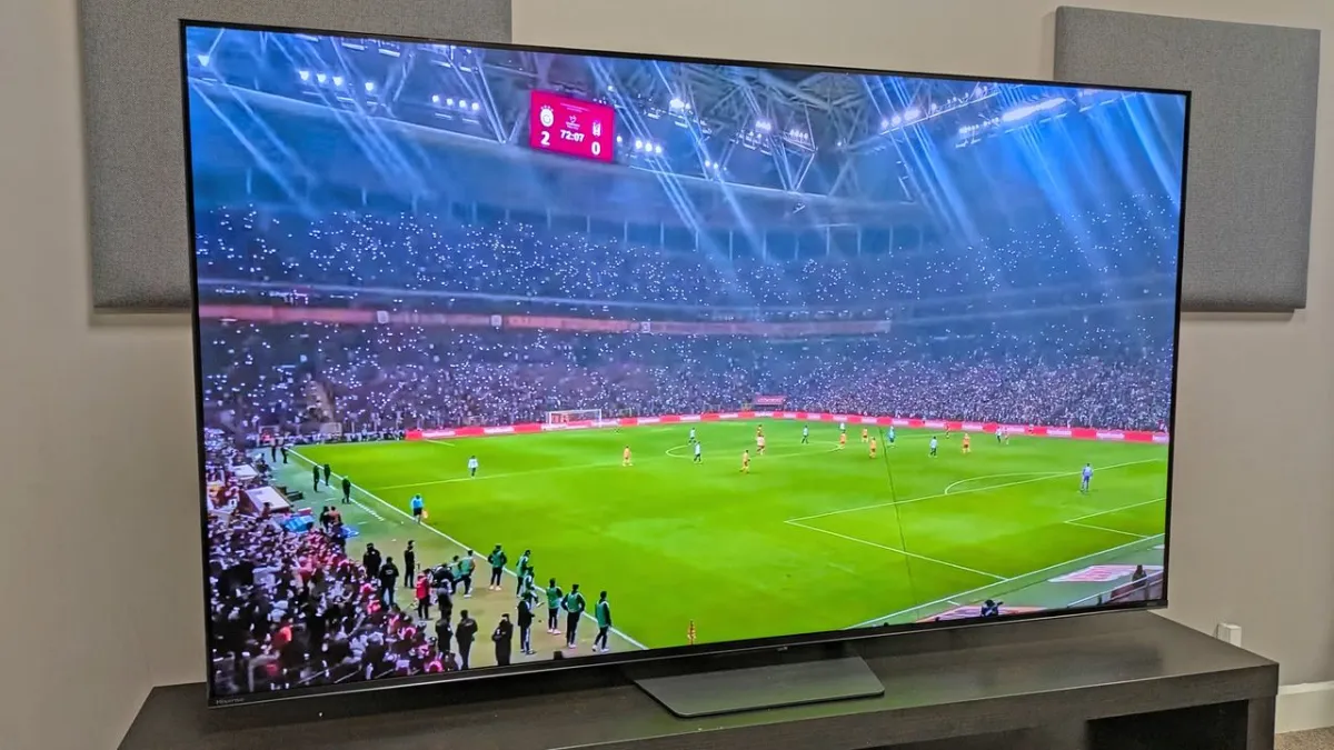 Three televisions displaying soccer match footage to illustrate motion handling and brightness differences.