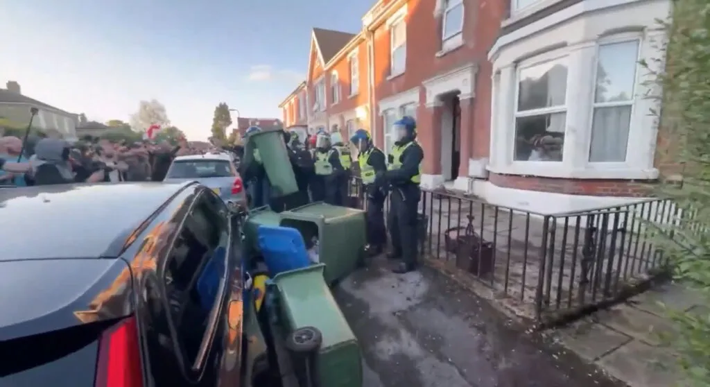 Protesters throw objects at police officers during a Southampton demonstration over a student murder conviction.