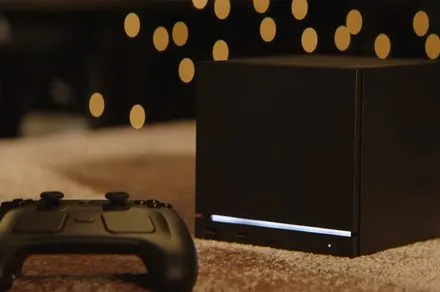 The Steam Machine console displays the SteamOS interface in a typical living room.