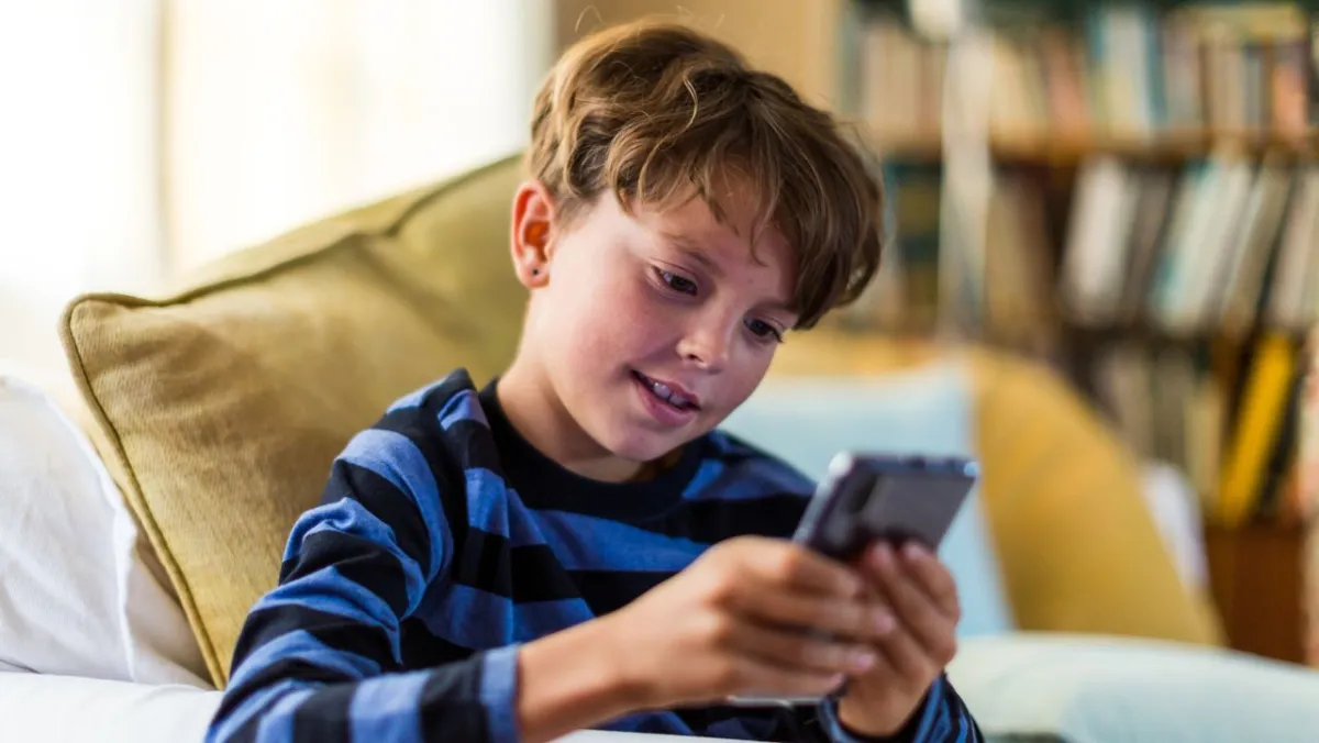 A child uses a supervised mobile device with active parental controls.