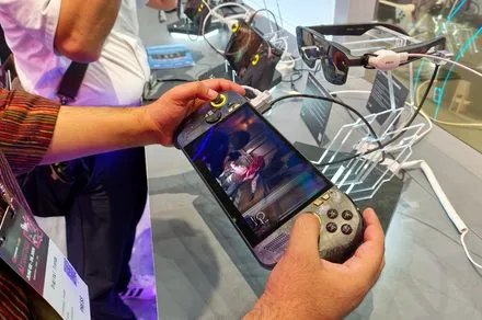 ASUS ROG Xbox Ally X20 handheld console with OLED display and AR glasses projecting a large virtual screen.