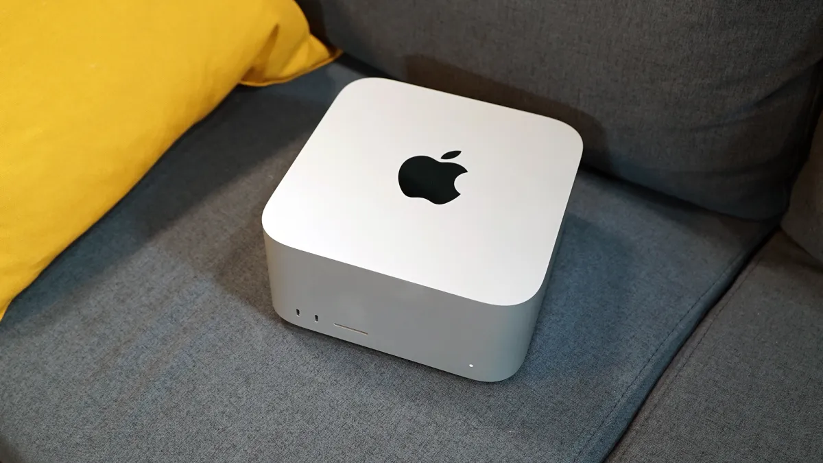 Silver Mac Studio desktop computer displaying its compact form factor and rear connectivity ports.