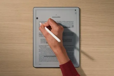 Kindle Scribe tablet without a front light, displaying the e-ink screen and pen storage compartment.