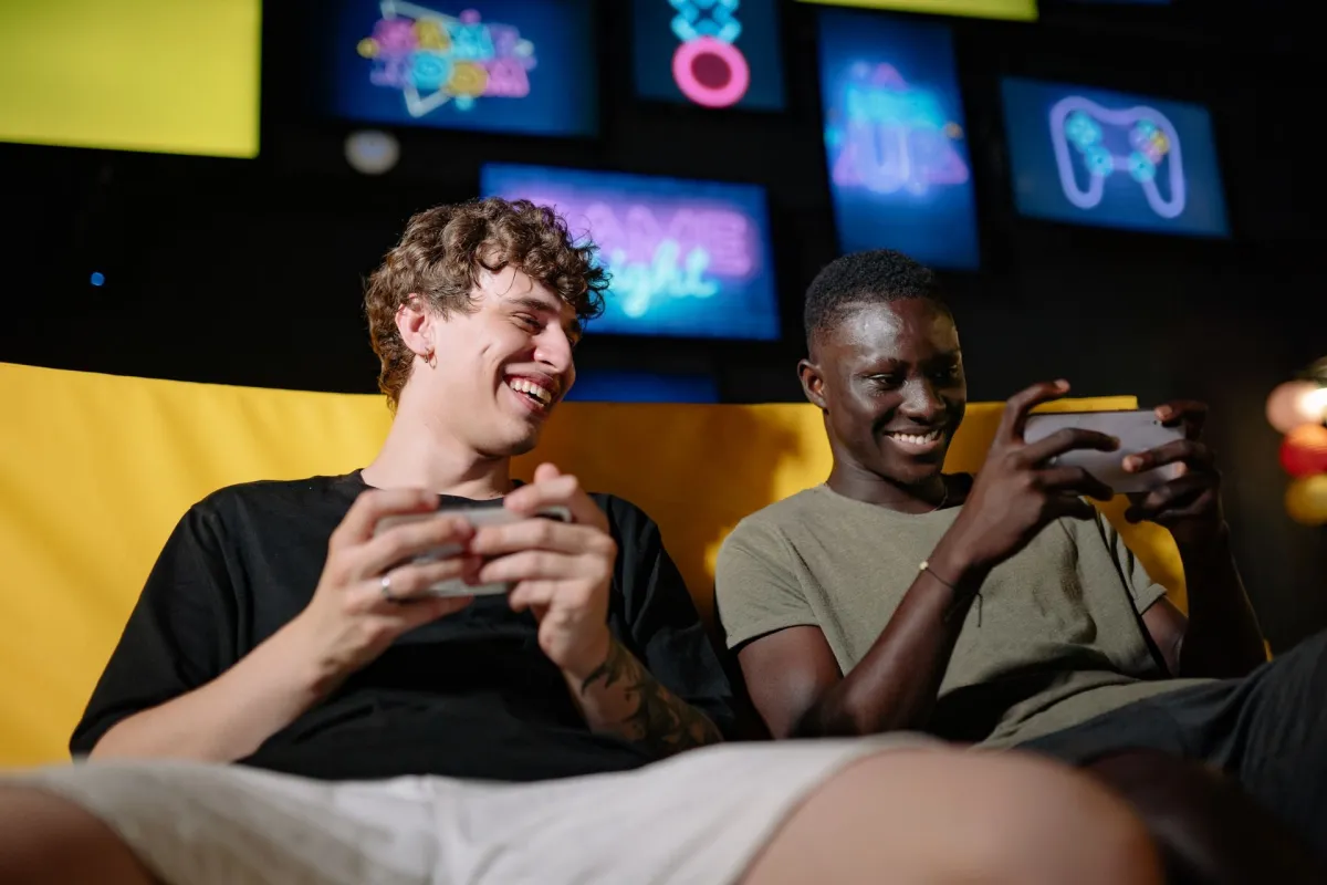 A person holds a smartphone displaying a mobile game interface during a casual gaming session.