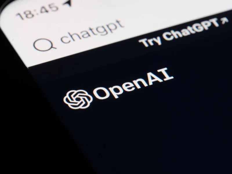 OpenAI logo displayed alongside financial documents related to its initial public offering filing.