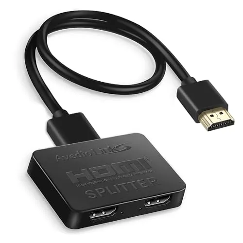A monitor splitter device connects a workstation to multiple display panels using visible signal cables.