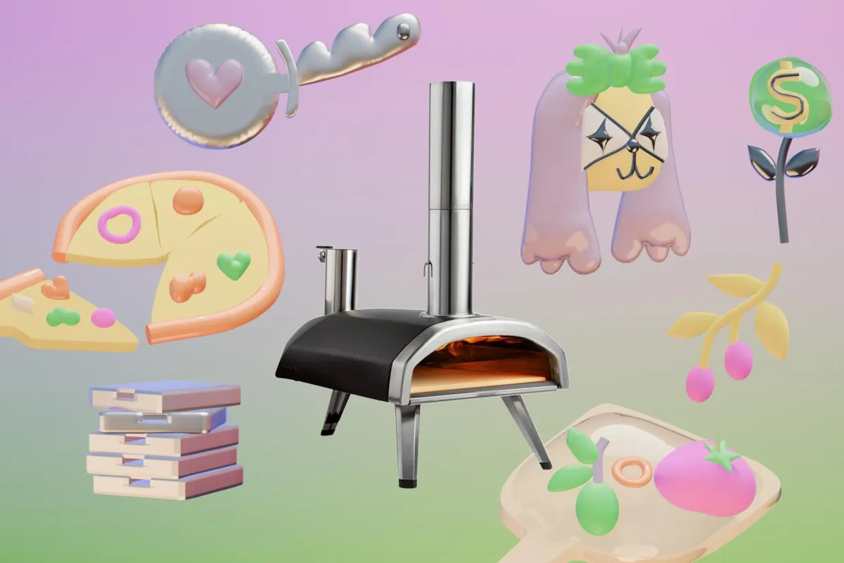 A compact portable pizza oven burns wood fuel during an outdoor cooking session.