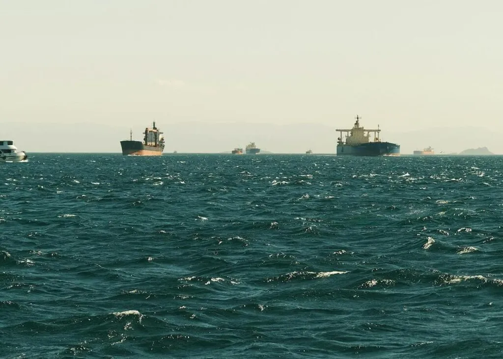 Commercial vessels navigate the Strait of Hormuz following a diplomatic agreement to resume safe maritime passage.
