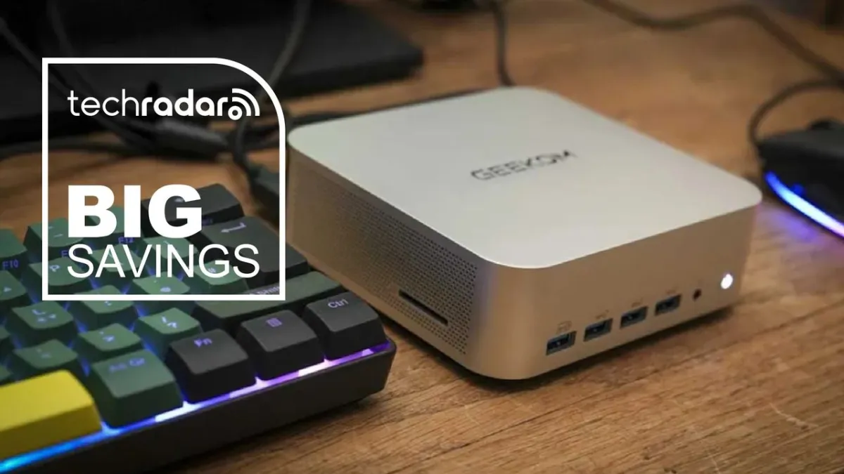 A compact Windows 11 mini PC rests on a clean workspace desk.